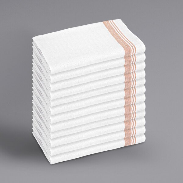 A stack of tan towels with orange stripes.