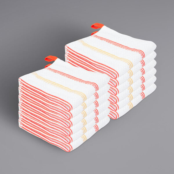 A stack of white towels with saffron stripes.
