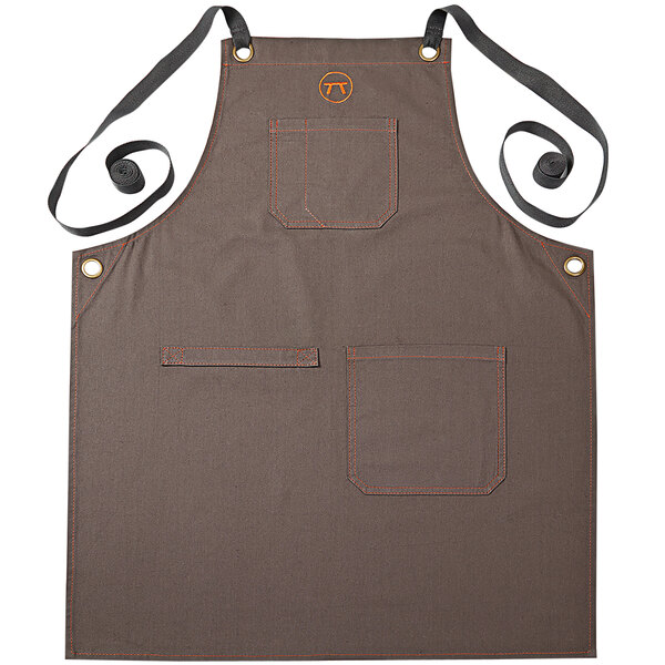 An Outset brown canvas apron with black straps and pockets.