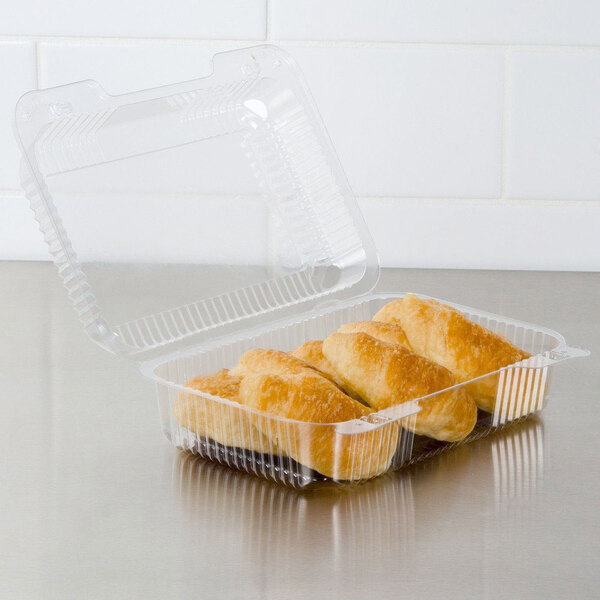 A Dart clear plastic container with two pastries inside.