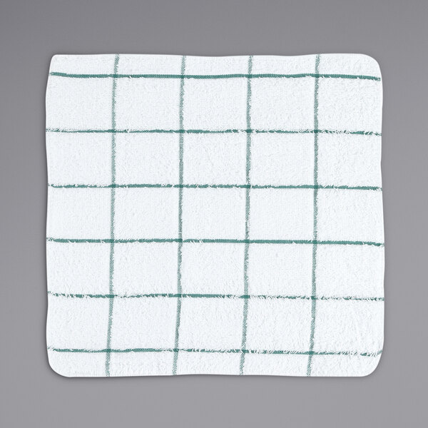 A white terry dish cloth with green windowpane lines.