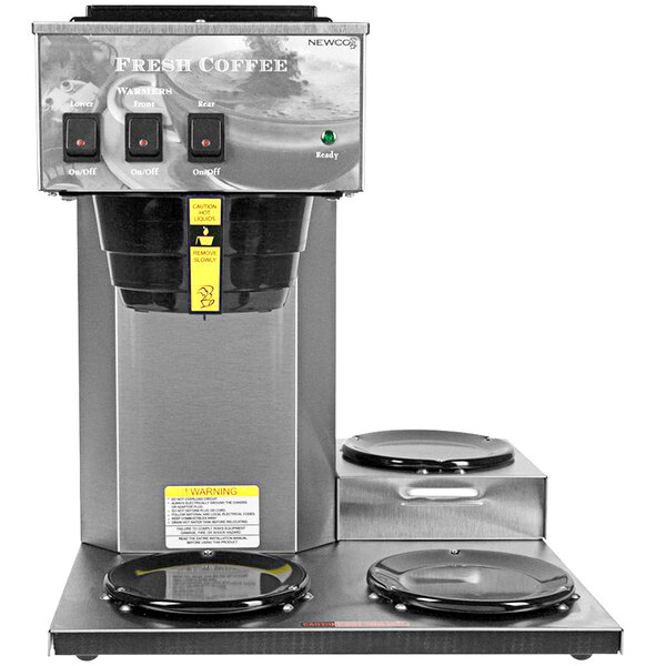 A Newco pourover coffee brewer with three warmers on a counter.