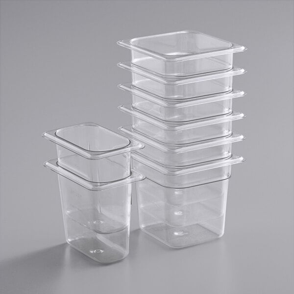 A stack of clear plastic Vigor food pans.