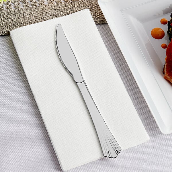 A Visions heavy weight silver plastic knife on a napkin.