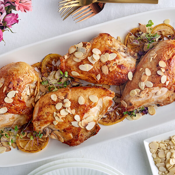 A piece of chicken with Regal Blanched Sliced Almonds on top.