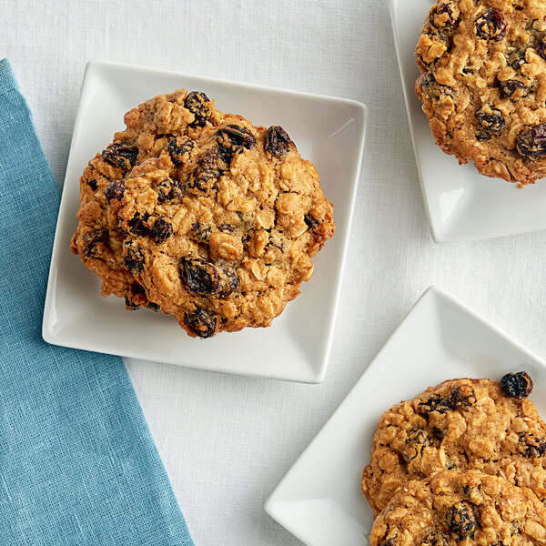 A close up of a Regal Thompson raisin oatmeal cookie on a white plate.