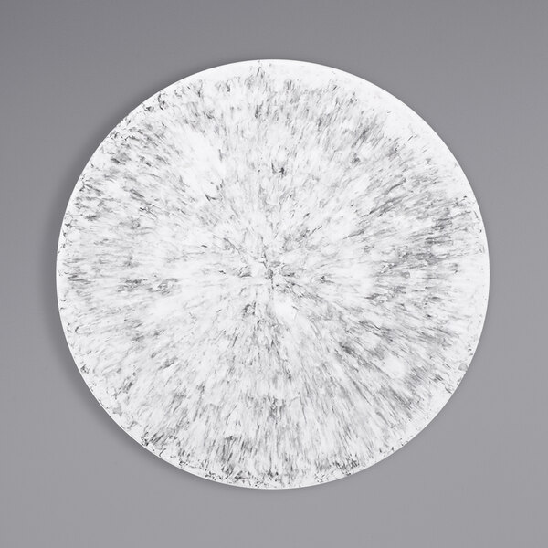 A white circular plate with a black marble embossed circle.