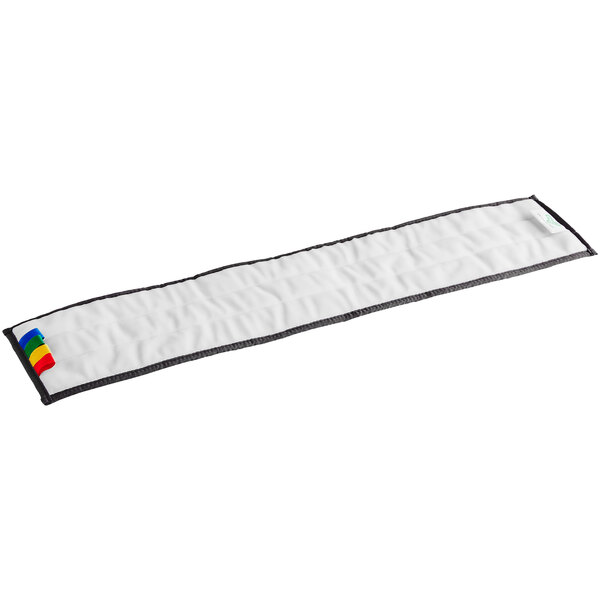 A white rectangular cleaning pad with colorful stripes.