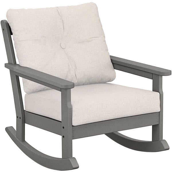 A POLYWOOD Vineyard Slate Grey rocking chair with a natural linen cushion.