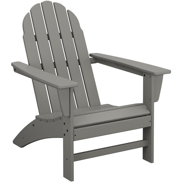 A POLYWOOD slate grey Adirondack chair with armrests.