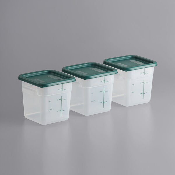 A row of Vigor translucent square plastic food storage containers with green lids.