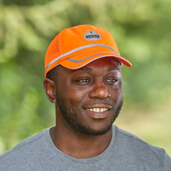 A man wearing an orange Ergodyne high visibility baseball cap.
