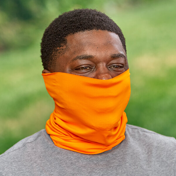 An orange Ergodyne Cooling Multi-Band worn as a neck gaiter.