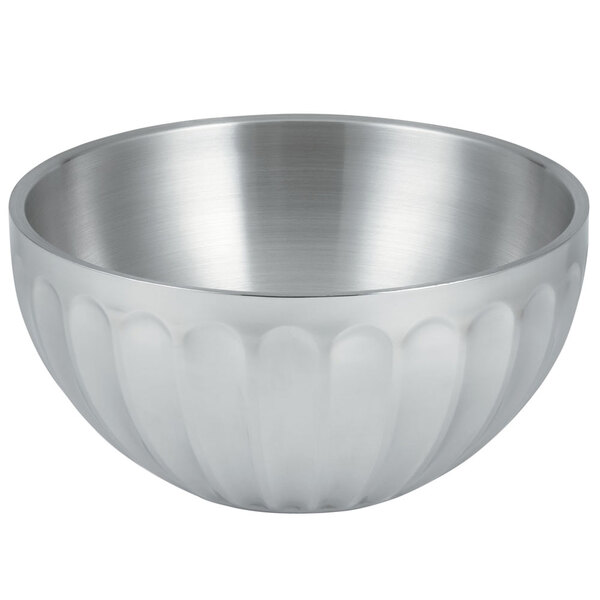 A silver Vollrath fluted serving bowl with a curved design.