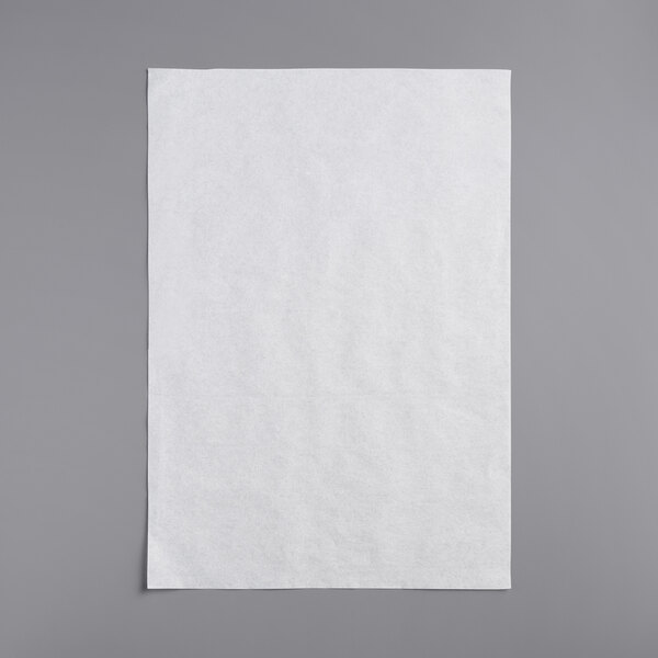 A white Frymaster filter paper sheet on a gray surface.