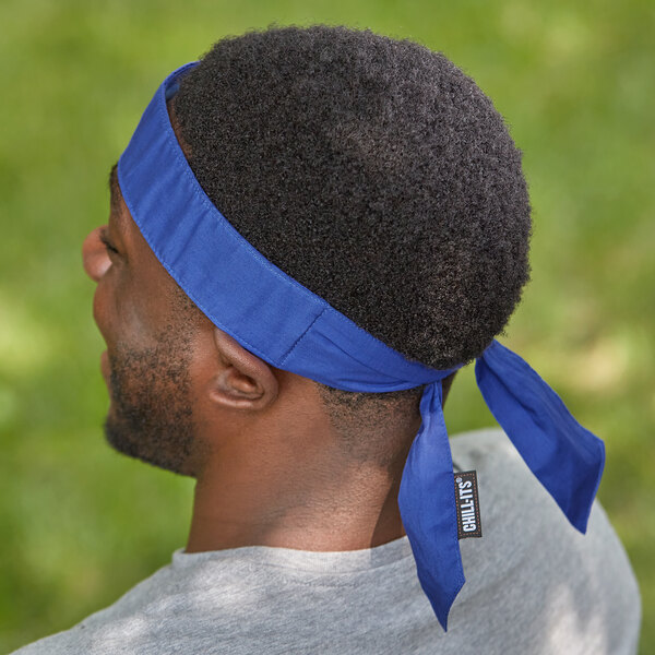 A man wearing a blue Ergodyne Chill-Its evaporative cooling bandana on his head.