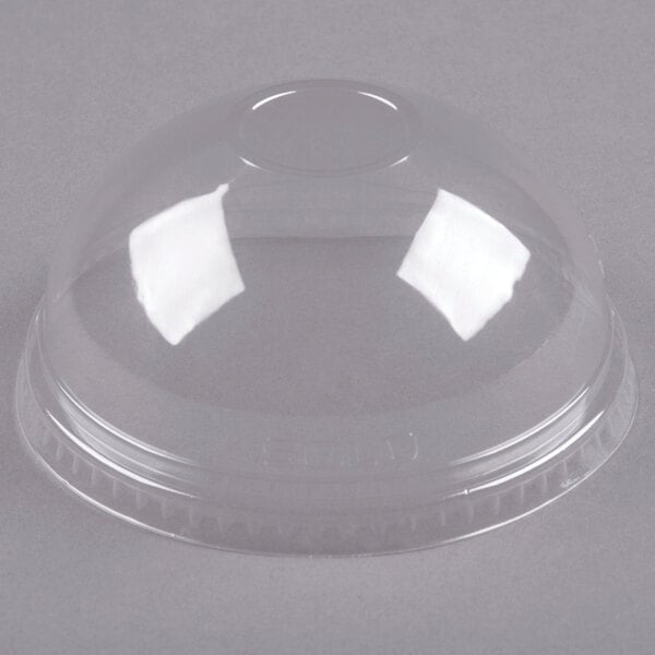 A clear plastic cup with a Dart clear plastic dome lid on top.