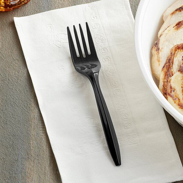A black plastic fork on a plate with food.