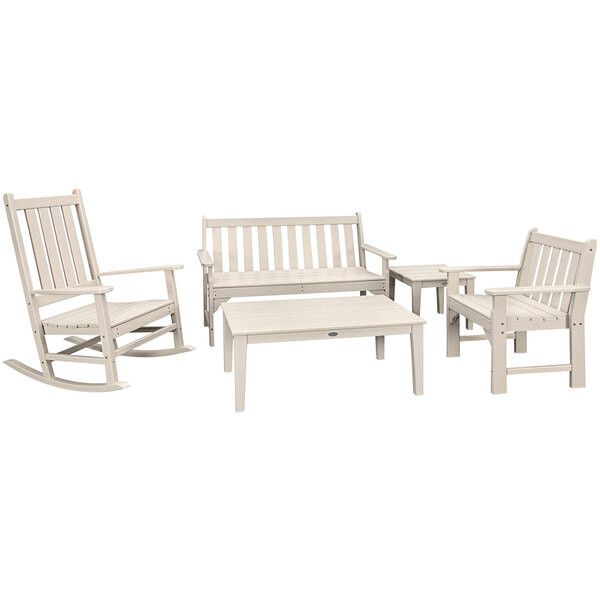 A white POLYWOOD outdoor bench and chair set with a table.