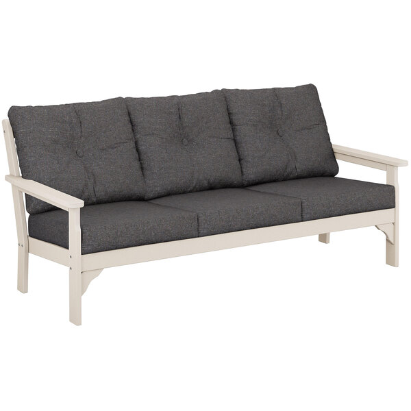 A POLYWOOD Vineyard outdoor sofa with a white frame and grey cushions.