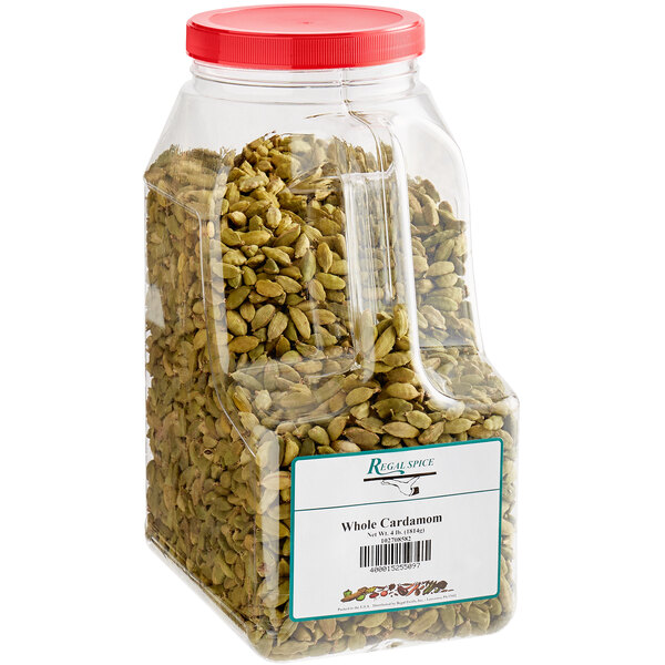 A plastic container of green Regal Whole Cardamom seeds.