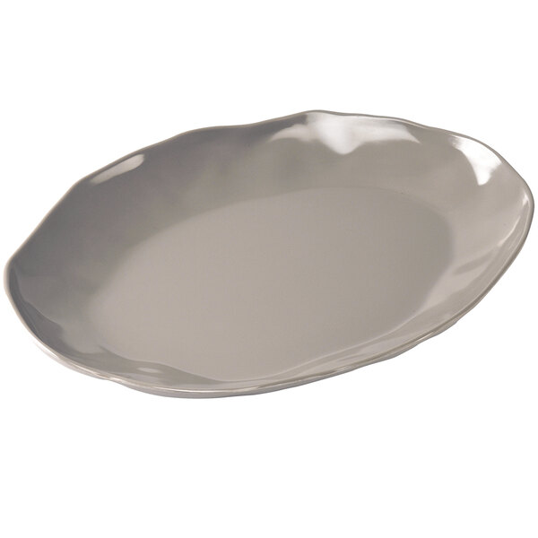 A white Cal-Mil melamine platter with wavy edges.