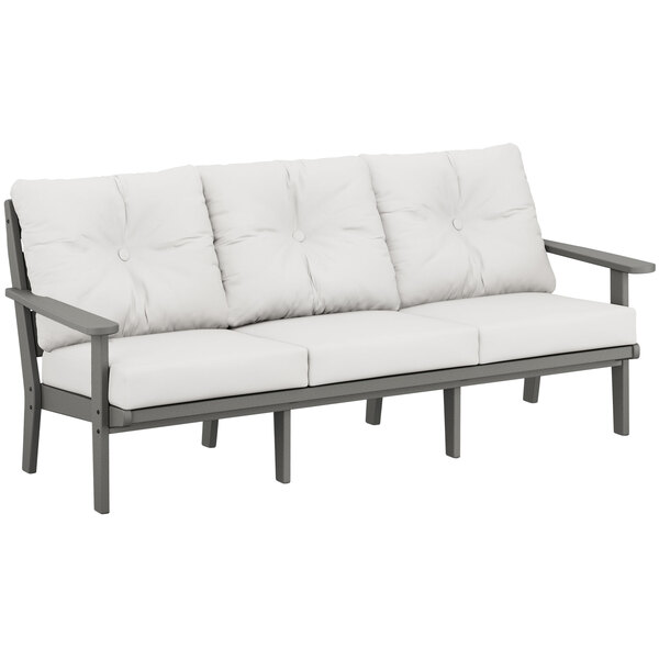 A white outdoor sofa with a gray frame and wooden legs.