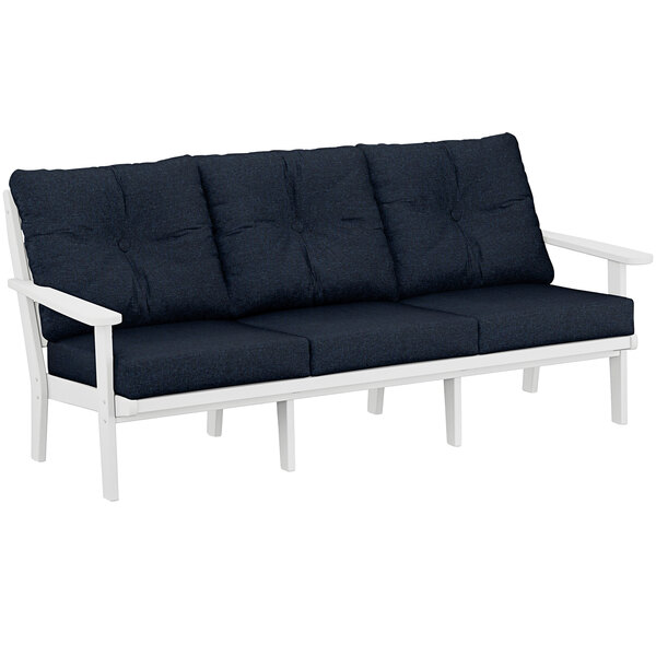 A white POLYWOOD outdoor sofa with navy cushions.