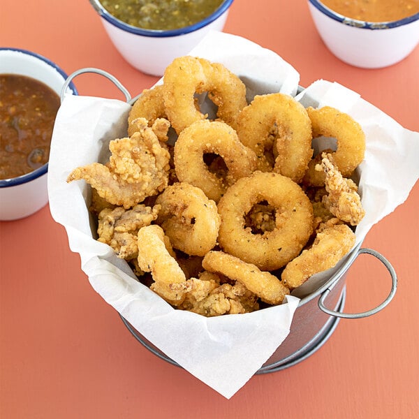 A close up of a plate of Mrs. Friday's lightly breaded calamari rings and tentacles.