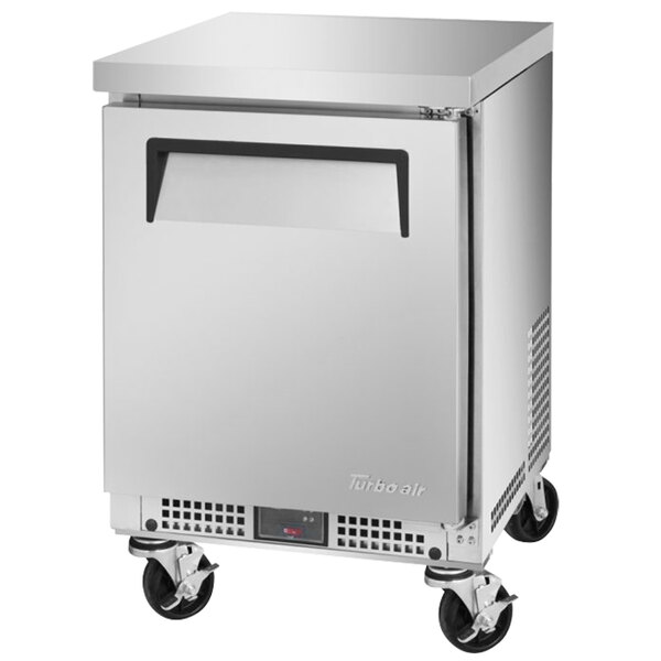 A silver Turbo Air undercounter refrigerator with wheels.
