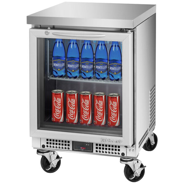 A Turbo Air undercounter refrigerator with soda cans and bottles inside.