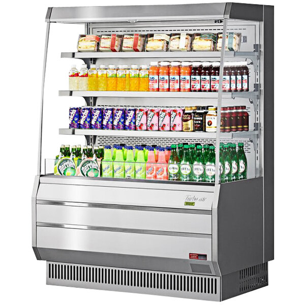 A white and silver Turbo Air vertical open display case with drinks and beverages.