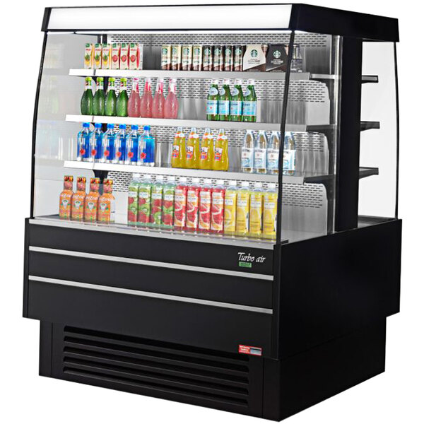 A black Turbo Air square island display case with drinks and beverages on it.