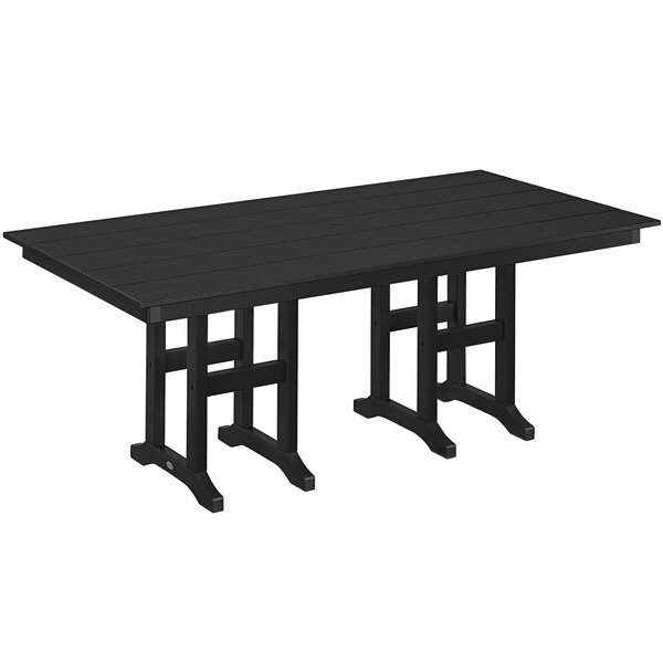 A black POLYWOOD dining table with legs set up outdoors.