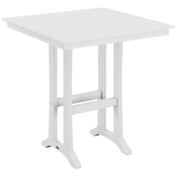 A white POLYWOOD table with wooden trestle legs.