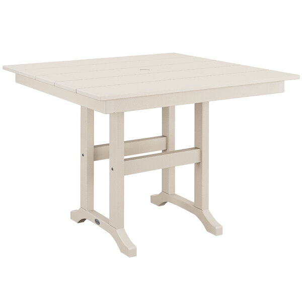 A white POLYWOOD dining table with wooden legs.