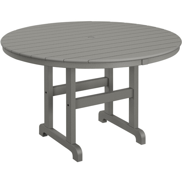 A POLYWOOD round slate grey outdoor dining table with legs.