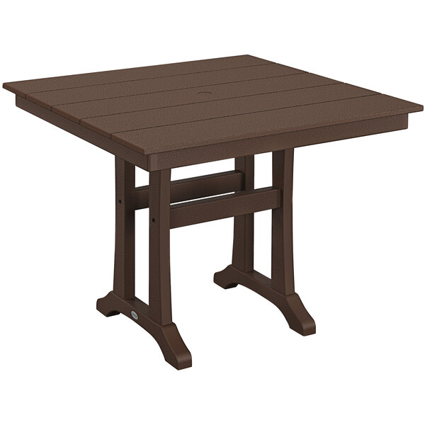 A brown POLYWOOD table with trestle legs on an outdoor patio.