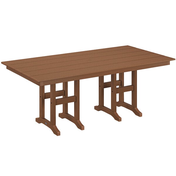 A brown POLYWOOD teak dining table with legs set up outdoors.