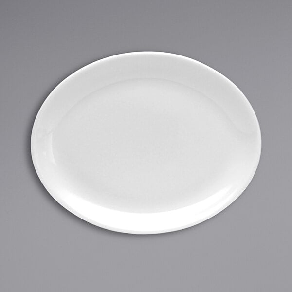 An Oneida Tundra white china platter with a white rim on a gray surface.