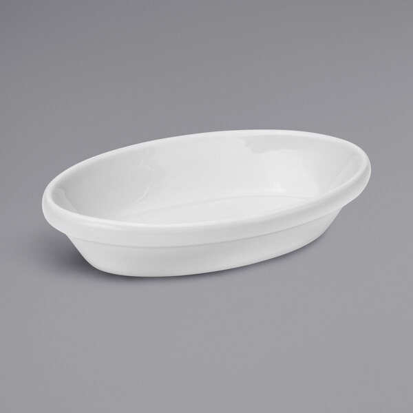 A white oval dish on a gray surface.