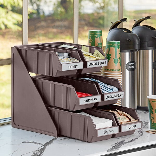 A brown Choice 3-tier organizer with green and brown cups in the bins.