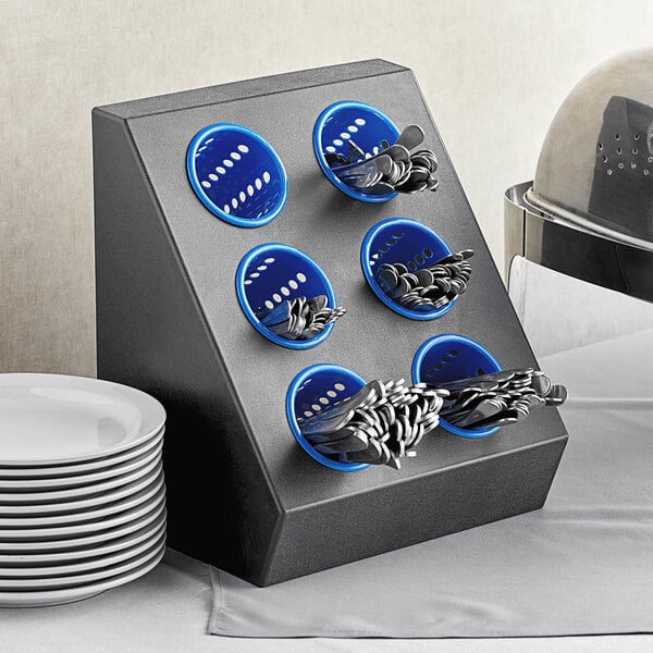 A black and blue Choice flatware organizer with blue plastic cylinders holding silverware.