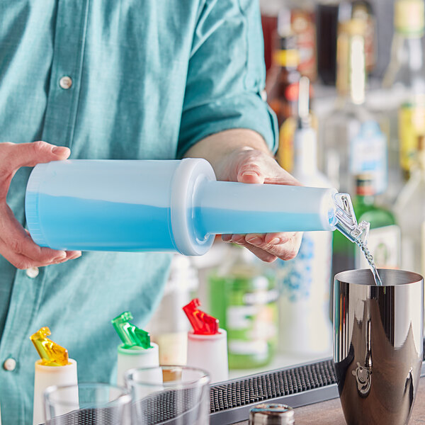A man pouring liquid from a metal object into a blue Choice plastic pour bottle.