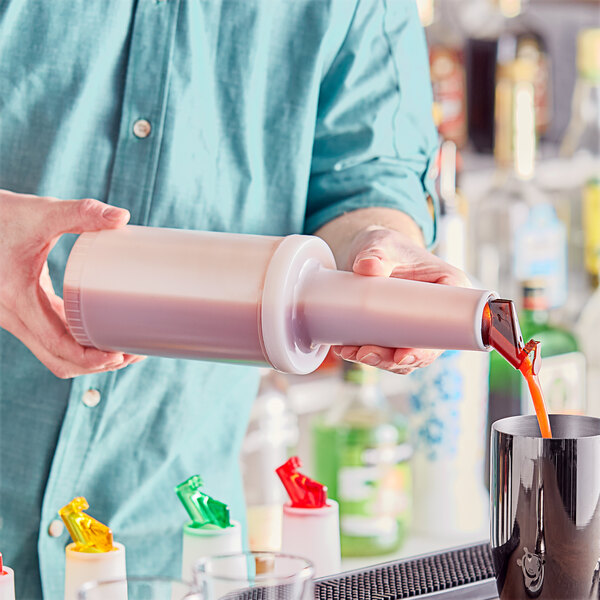 A person pouring liquid from a Choice plastic pour bottle with a brown flip top and cap.
