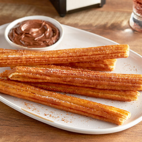 A plate of White Toque plain churros with chocolate spread.