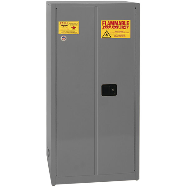 A grey steel Eagle safety cabinet with yellow labels.