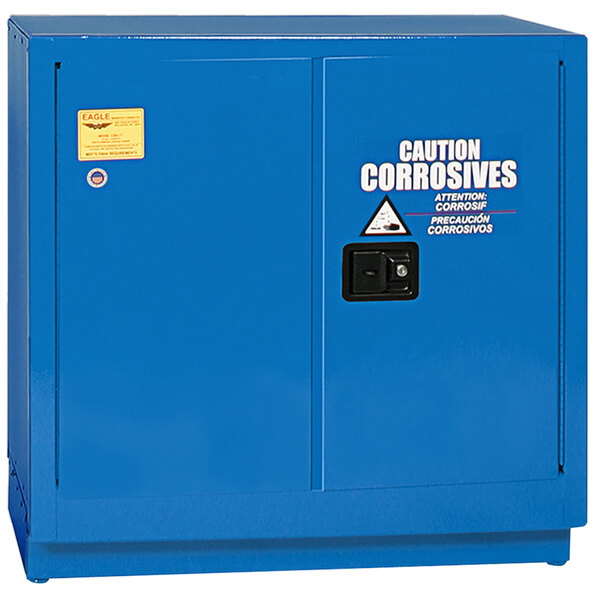 A blue metal Eagle safety cabinet with a black handle and a warning label.