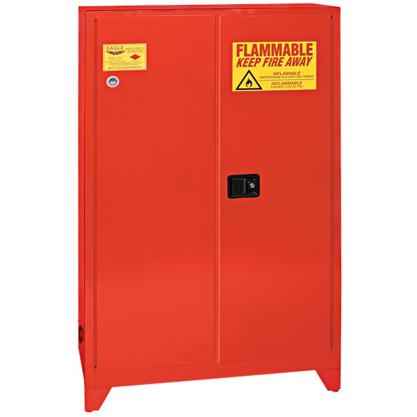 A red metal Eagle safety cabinet with yellow warning signs on it.