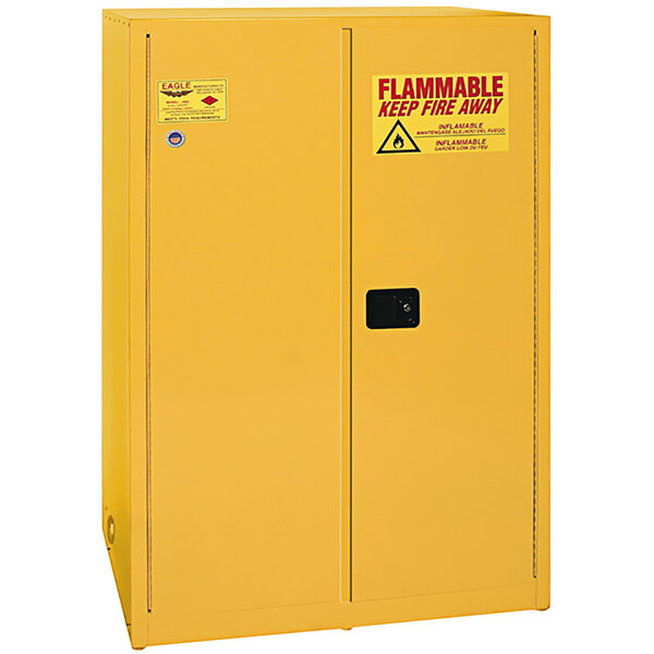 A yellow Eagle Manufacturing safety cabinet with a warning sign on the doors.